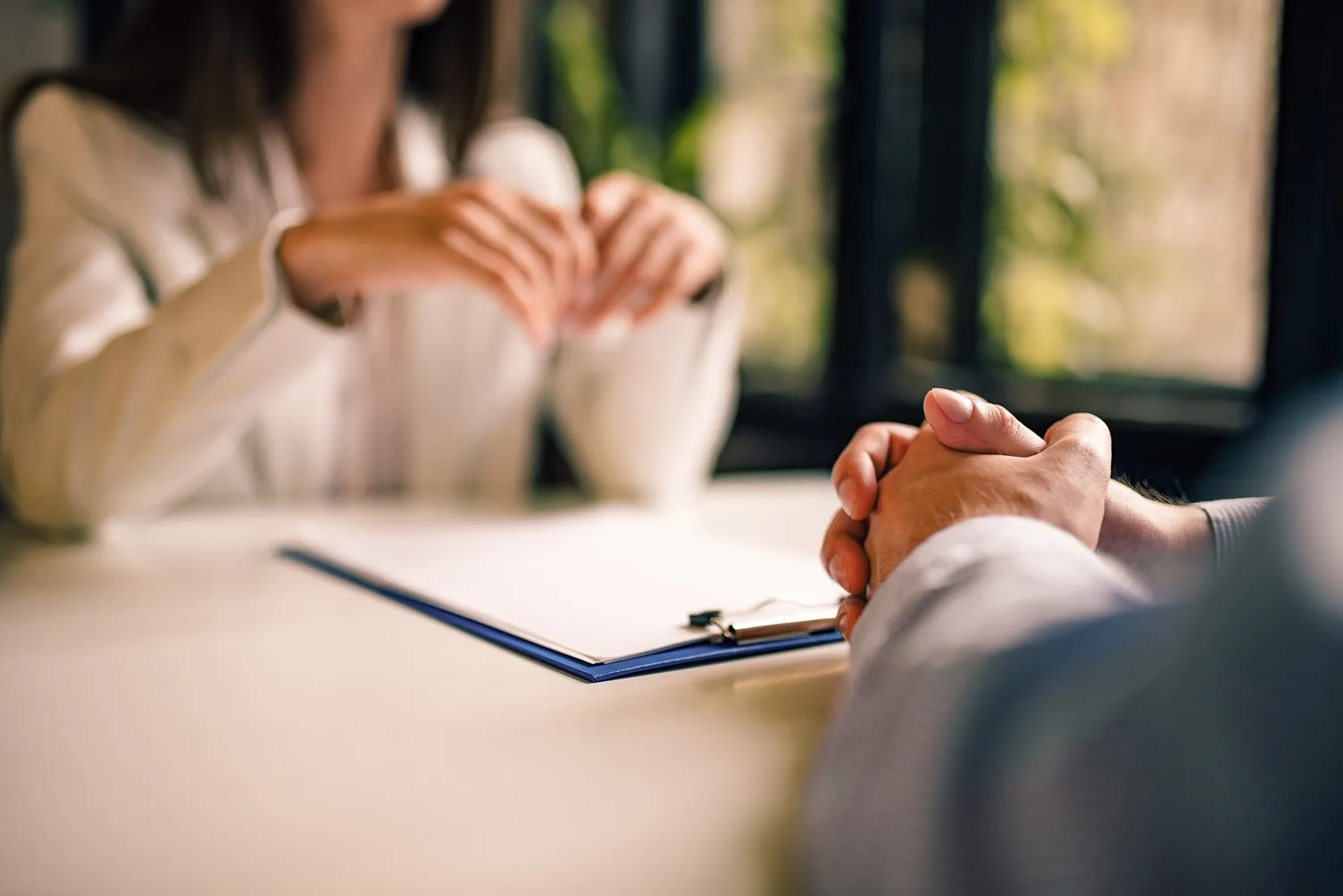 A female client speaking with an attorney.