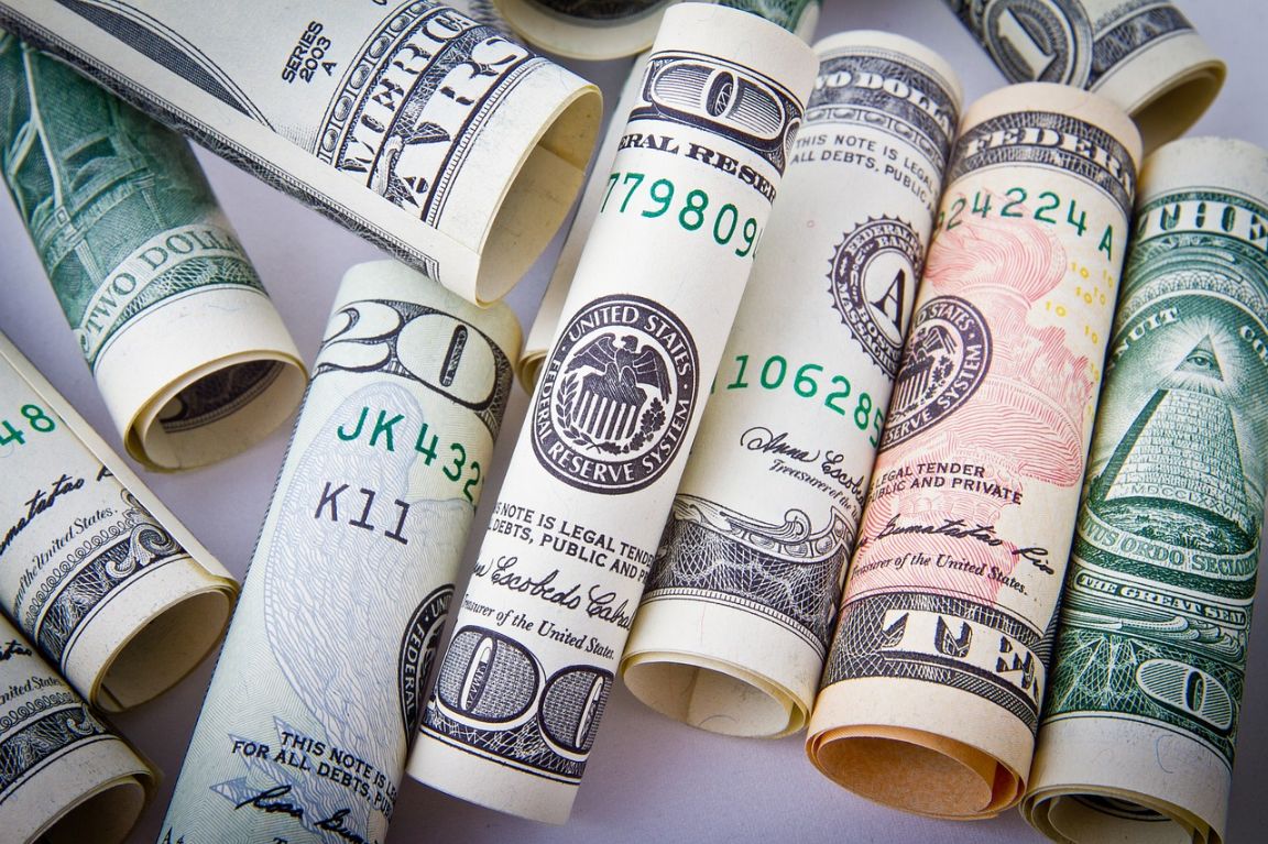 Different money bills rolled up.